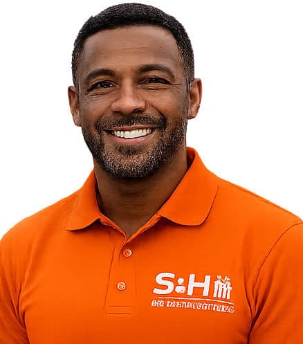 Man smiling in orange polo shirt with S&H logo for web design.